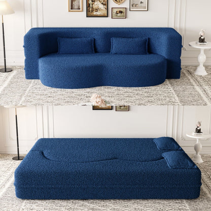 Futon sofa in blue teddy fabric with two foam-filled pillows on floor on Tampa Home & Garden Store