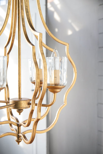 4-light gold metal chandelier with curved arms and glass shade cups HouseOfZazla on Tampa Home & Garden Store