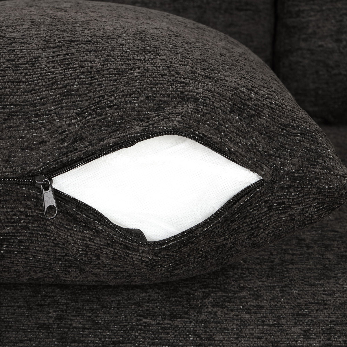 Sleeper sectional couch close-up in black textured fabric with visible zipper and white lining on Tampa Home & Garden Store
