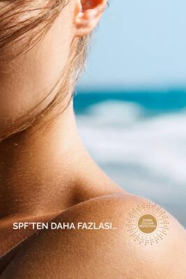 Esthederm Institut Photo Reverse Stick SPF 50+ sunscreen on beach model; anti-dark spot on Tampa Home & Garden Store