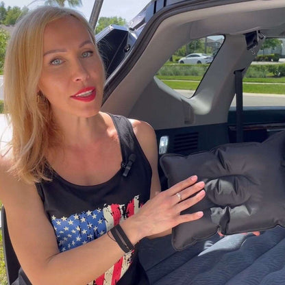 Umbrauto SUV air mattress 1.0 in gray held by woman beside open trunk, car camping setup on Tampa Home & Garden Store