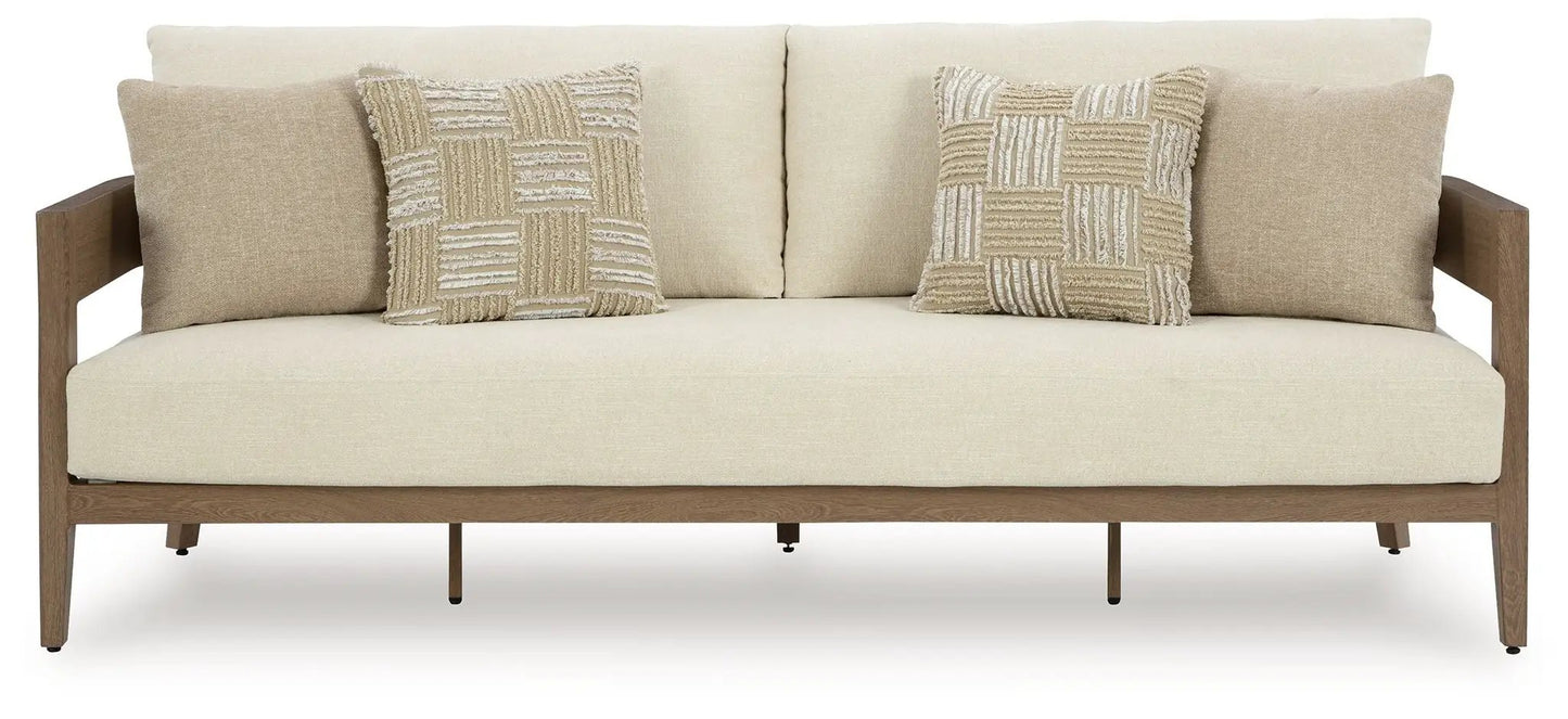 Serene Bay sofa with beige upholstery, dark brown wooden frame, and two patchwork cushions on Tampa Home & Garden Store