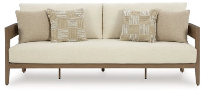 Serene Bay sofa with beige upholstery, dark brown wooden frame, and two patchwork cushions on Tampa Home & Garden Store