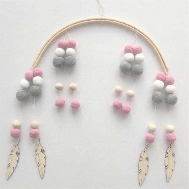 Stevvex crib mobile with wooden beads and pink gray white wool balls, feather pendants on Tampa Home & Garden Store