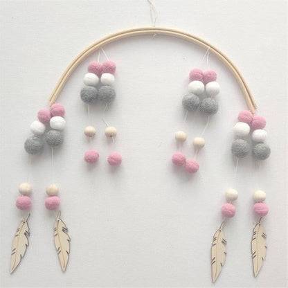 Stevvex crib mobile with wooden beads and pink gray white wool balls, feather pendants on Tampa Home & Garden Store