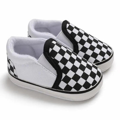 Pair of Stevvex baby shoes in black-and-white checkerboard slip-ons with soft PU leather soles on Tampa Home & Garden Store