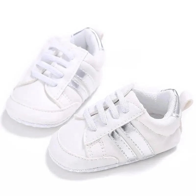 White baby lace-up sneakers with silver heel detail, soft sole toddler shoes on Tampa Home & Garden Store