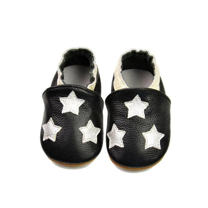 Stevvex baby leather moccasin booties, black with white stars, fluffy lining, pair on Tampa Home & Garden Store