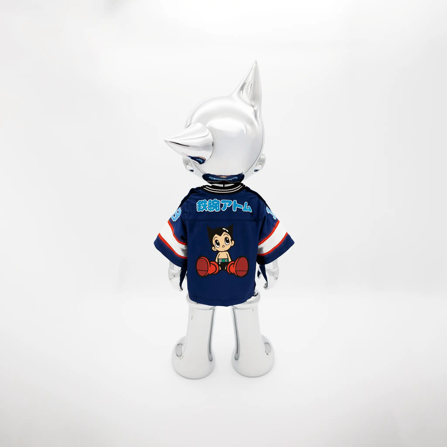 Astro Boy Reimagined action figure head in metallic silver, blue jersey with cartoon art on Tampa Home & Garden Store