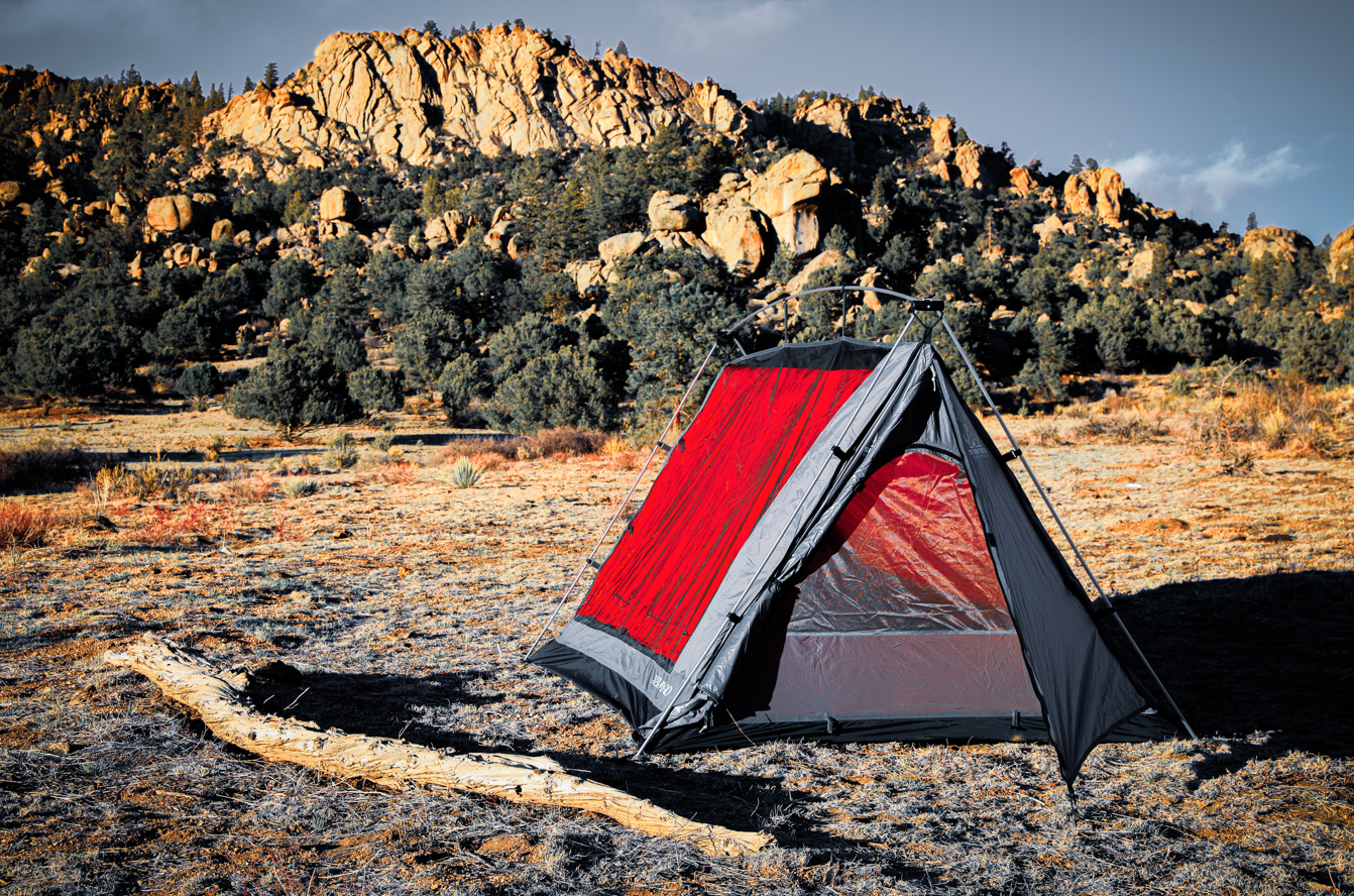 Sky View Duo Tent with red panels and gray rainfly set up on a desert campsite on Tampa Home & Garden Store