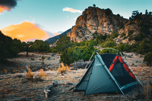Sky View Duo Tent teal with red mesh panels pitched on a desert campsite by rugged hills on Tampa Home & Garden Store