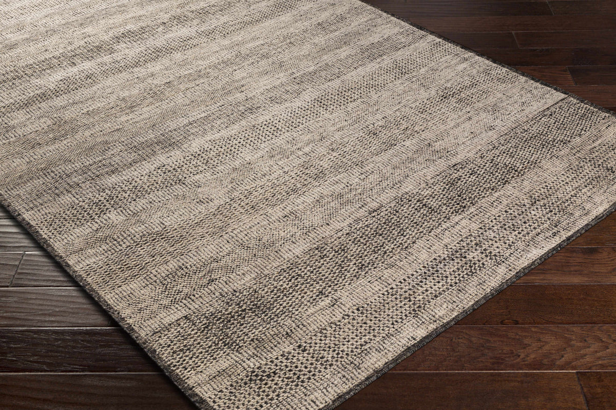 Balaclava Area Rug beige gray textured weave on dark wood floor on Tampa Home & Garden Store