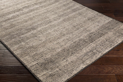 Balaclava Area Rug beige gray textured weave on dark wood floor on Tampa Home & Garden Store