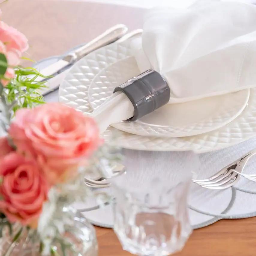 Brazilian Bamboo Napkin Ring by Talah Home around white napkin on a white textured plate on Tampa Home & Garden Store