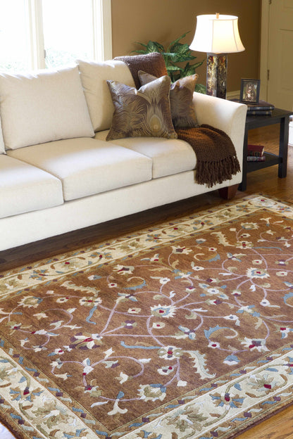 Batesburg Wool Area Rug by Boutique Rugs, brown field with cream border and pastel scrollwork on Tampa Home & Garden Store