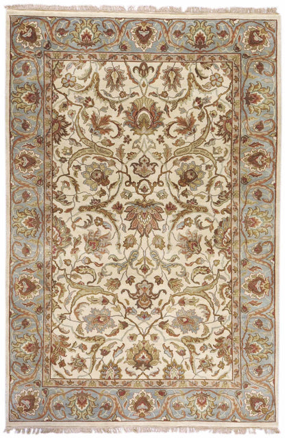 Baylis Area Rug by Boutique Rugs, cream field with blue border and floral motifs, fringe on Tampa Home & Garden Store