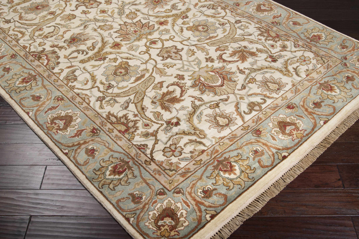 Baylis Area Carpet by Boutique Rugs, cream oriental rug with blue border and floral scrollwork on Tampa Home & Garden Store