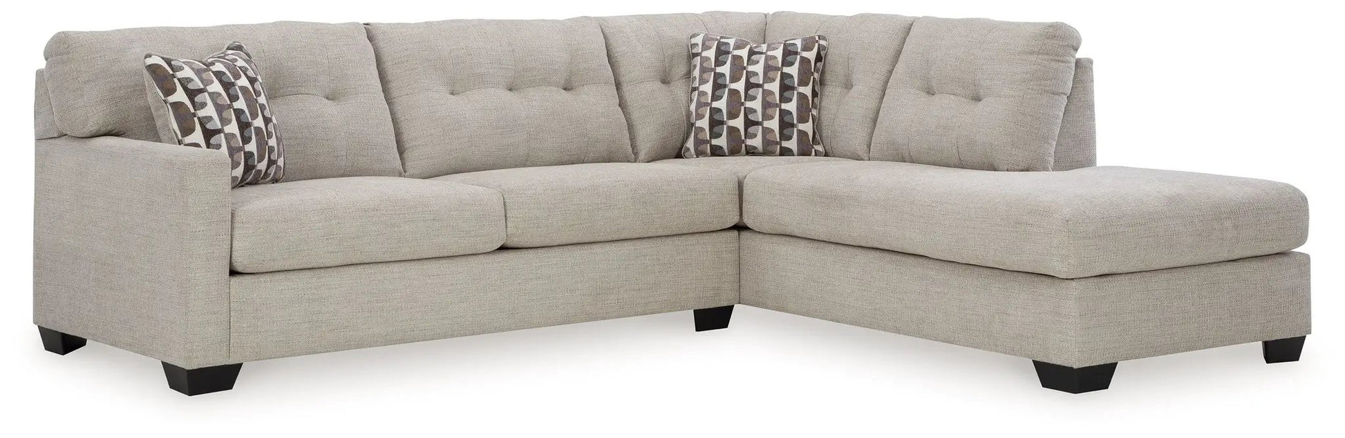 Mahoney sectional in beige fabric with tufted back cushions and two pillows on Tampa Home & Garden Store