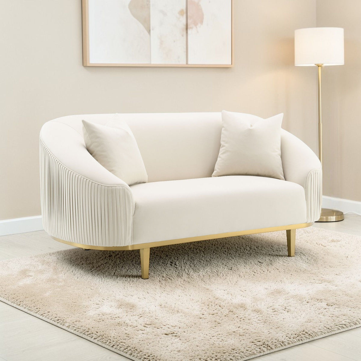 Ivory velvet loveseat with 2 pillows, curved arms, pleated sides, gold metal legs on Tampa Home & Garden Store