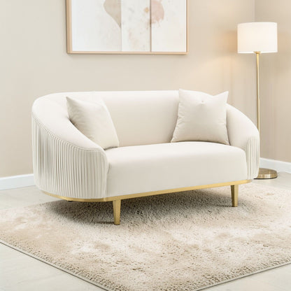 Ivory velvet loveseat with 2 pillows, curved arms, pleated sides, gold metal legs on Tampa Home & Garden Store