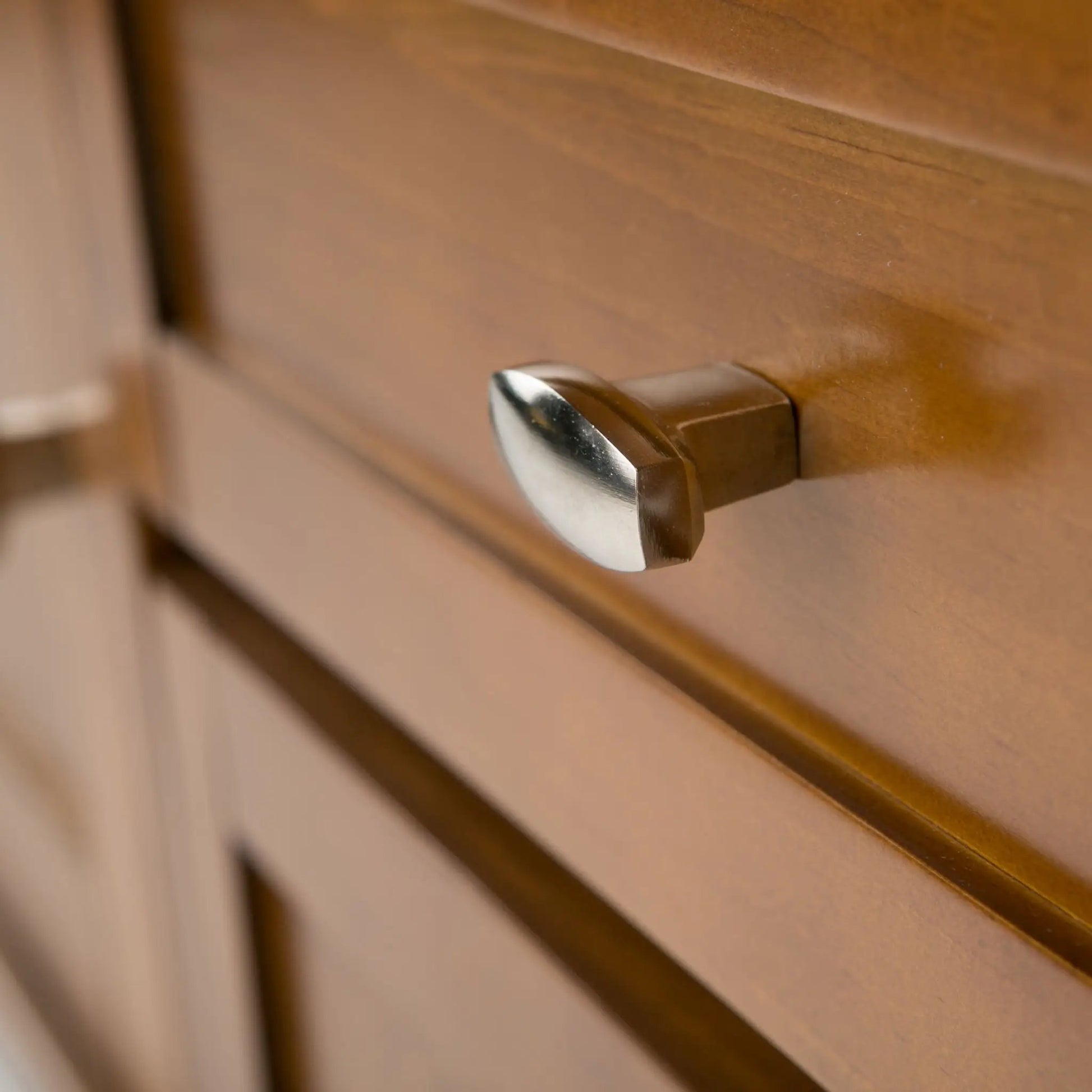 Warm Shaker TV media stand close-up in warm brown wood with brushed metal handles on Tampa Home & Garden Store