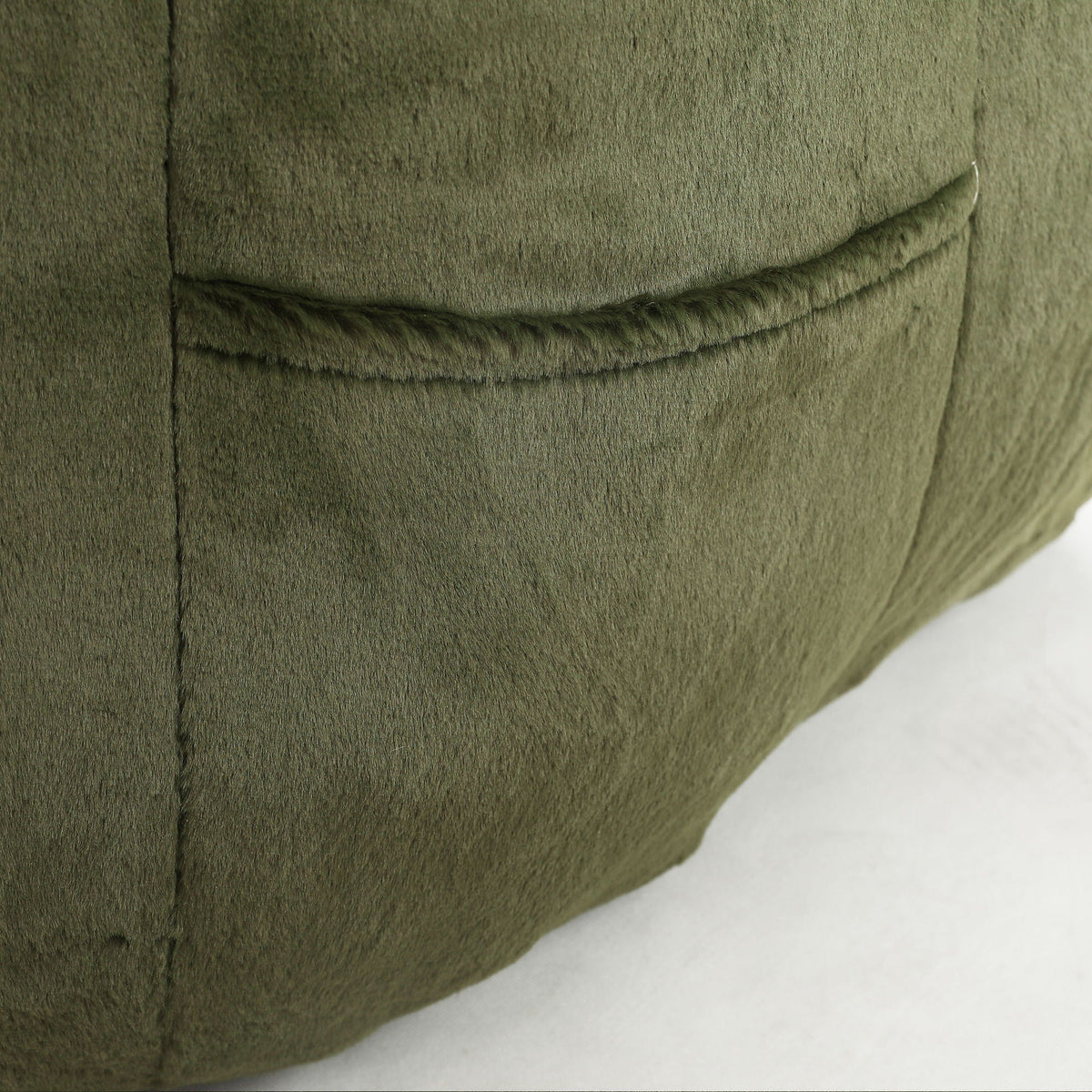Beanbag chair with armrests in olive green plush fabric, seam details on Tampa Home & Garden Store