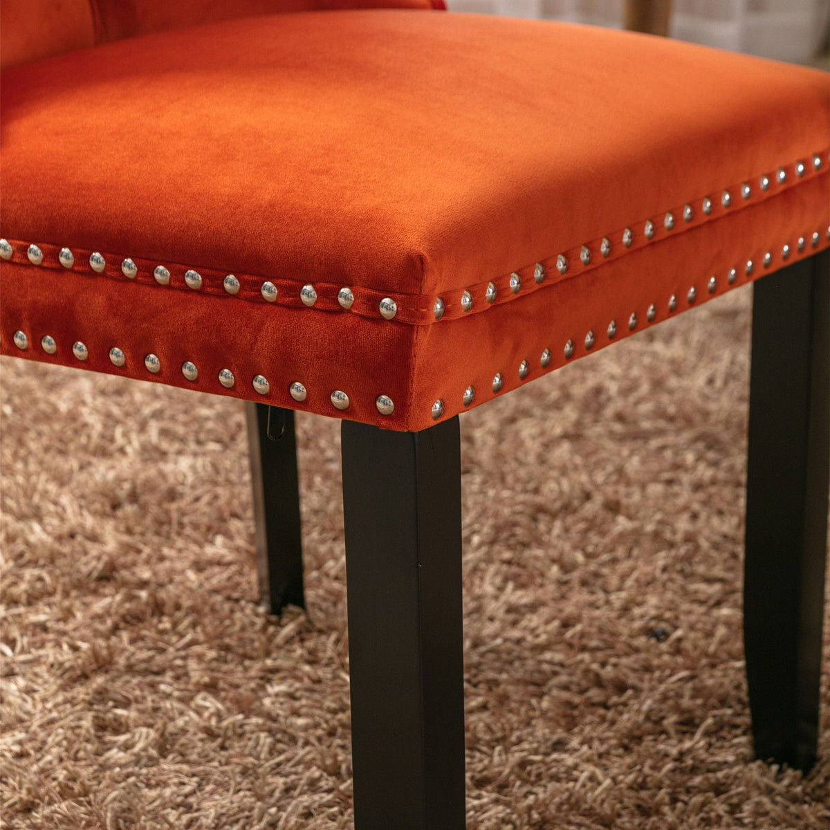 Tufted dining chair set in orange velvet with chrome nailhead trim and black legs on Tampa Home & Garden Store