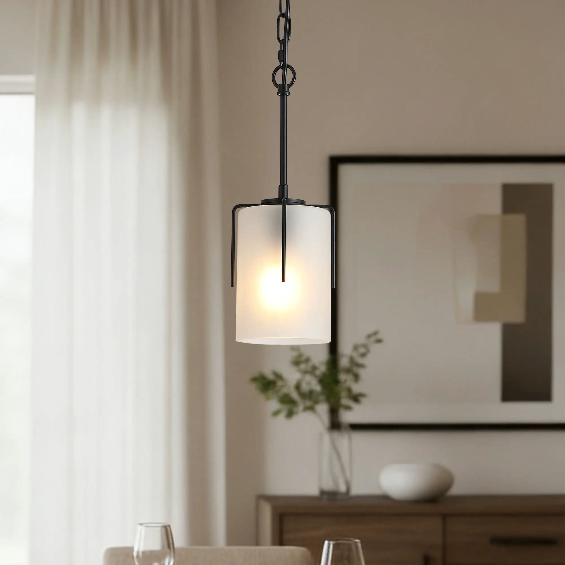 Adjustable cylindrical pendant light with black metal frame and frosted glass shade on Tampa Home & Garden Store