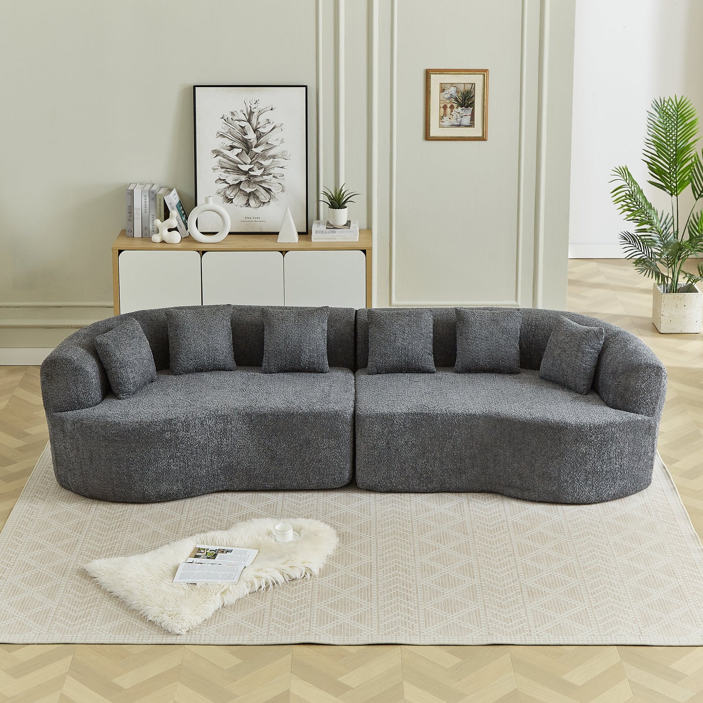 Curved sectional sofa in charcoal textured fabric with plush cushions in a modern living room on Tampa Home & Garden Store