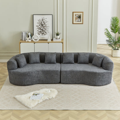 Curved sectional sofa in charcoal textured fabric with plush cushions in a modern living room on Tampa Home & Garden Store