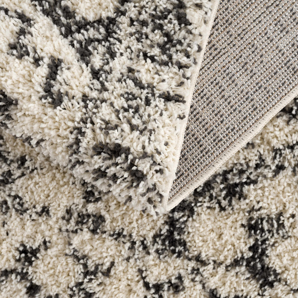 Buan Area Rug by Boutique Rugs, plush shaggy cream-gray pile with beige woven border on Tampa Home & Garden Store