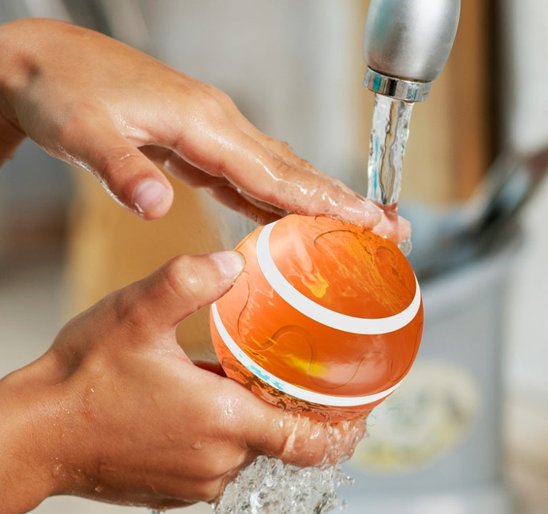 Sell My Stuff Wicked Ball cat toy orange self-rotating USB ball rinsed under running water on Tampa Home & Garden Store
