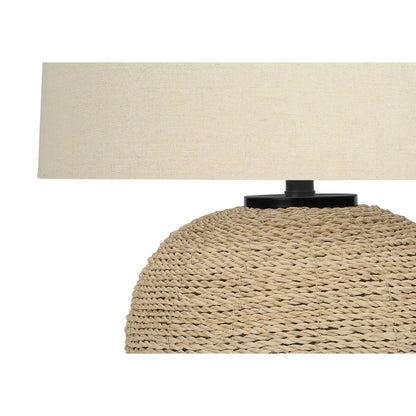 Table lamp with beige linen shade atop a large woven rattan base, transitional style on Tampa Home & Garden Store