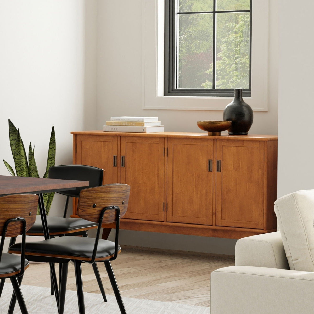 Brown 4-door sideboard buffet in warm wood finish with ample storage under a window on Tampa Home & Garden Store