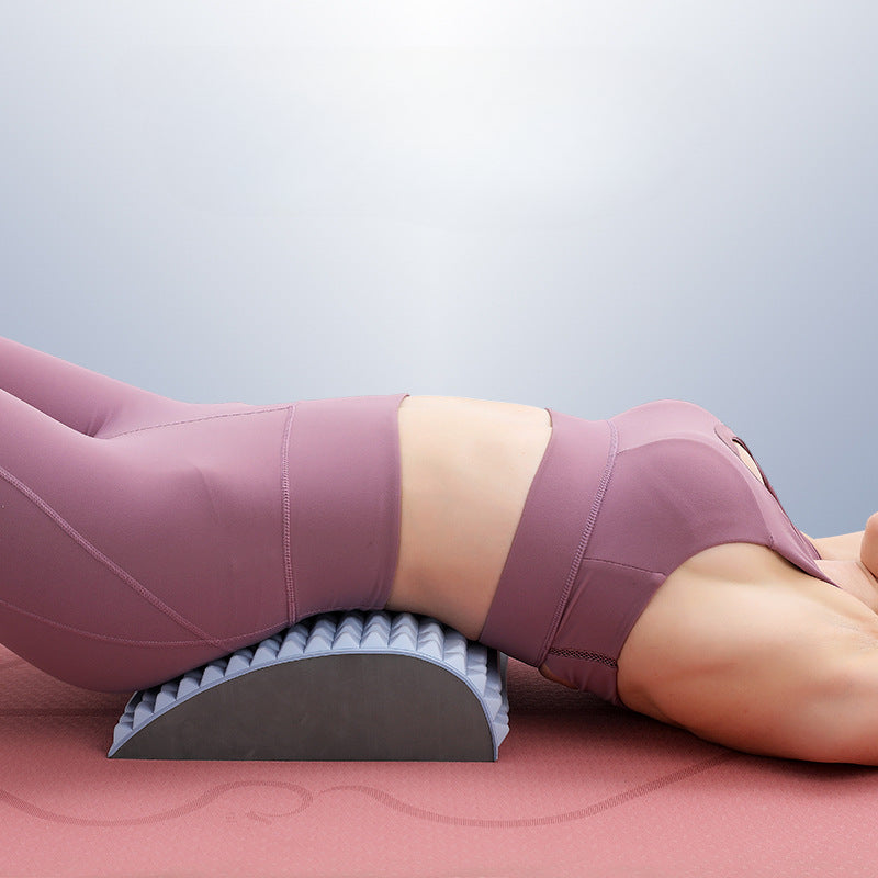 Perfecsy back stretcher pillow with ridged curved foam in gray under the torso on a yoga mat on Tampa Home & Garden Store