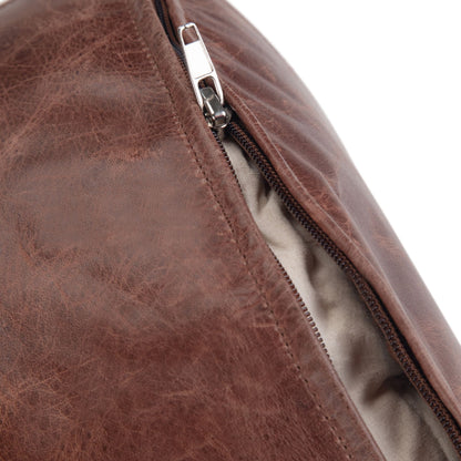 Handcrafted round pouf with distressed brown leather and visible zipper detail on Tampa Home & Garden Store