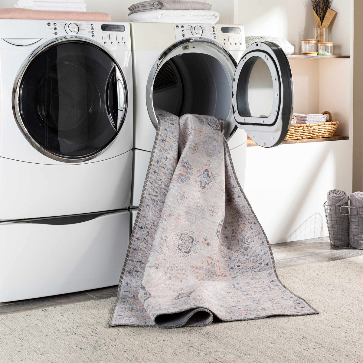 Beige Beckett washable rug by Boutique Rugs draped over laundry machines in a laundry room on Tampa Home & Garden Store