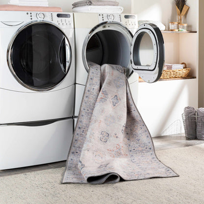 Beige Beckett washable rug by Boutique Rugs draped over laundry machines in a laundry room on Tampa Home & Garden Store