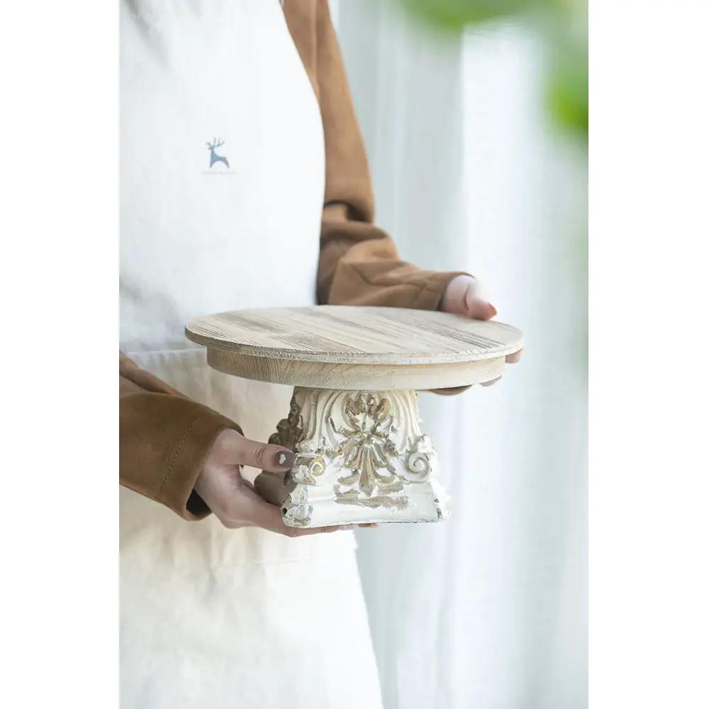 Cake stand with wood top on ornate cream pedestal base on Tampa Home & Garden Store