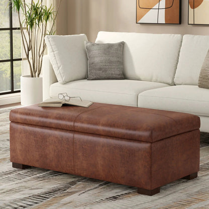 Gabbie upholstered storage ottoman coffee table in brown leather beside a white sofa on Tampa Home & Garden Store