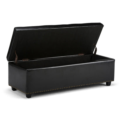 Hamilton upholstered storage ottoman in black faux leather with brass nailhead trim on Tampa Home & Garden Store