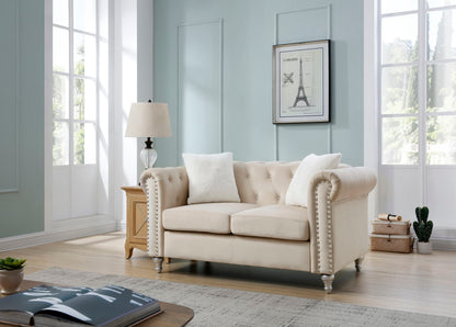 Contemporary beige loveseat with jeweled tufting and nailhead trim in a blue room on Tampa Home & Garden Store