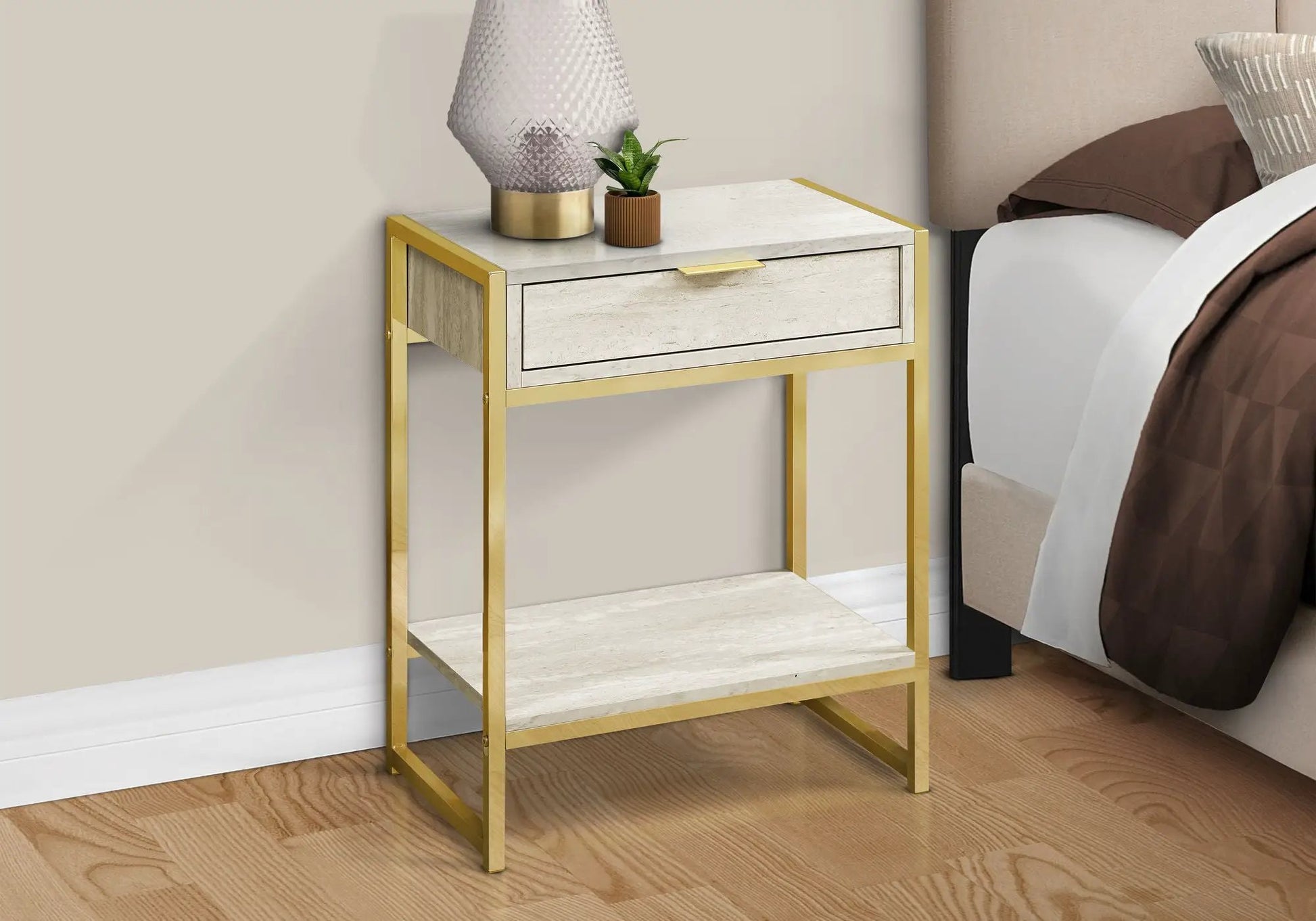 Accent Side Table with storage drawer, light stone top and gold frame by Unique Piece beside bed on Tampa Home & Garden Store