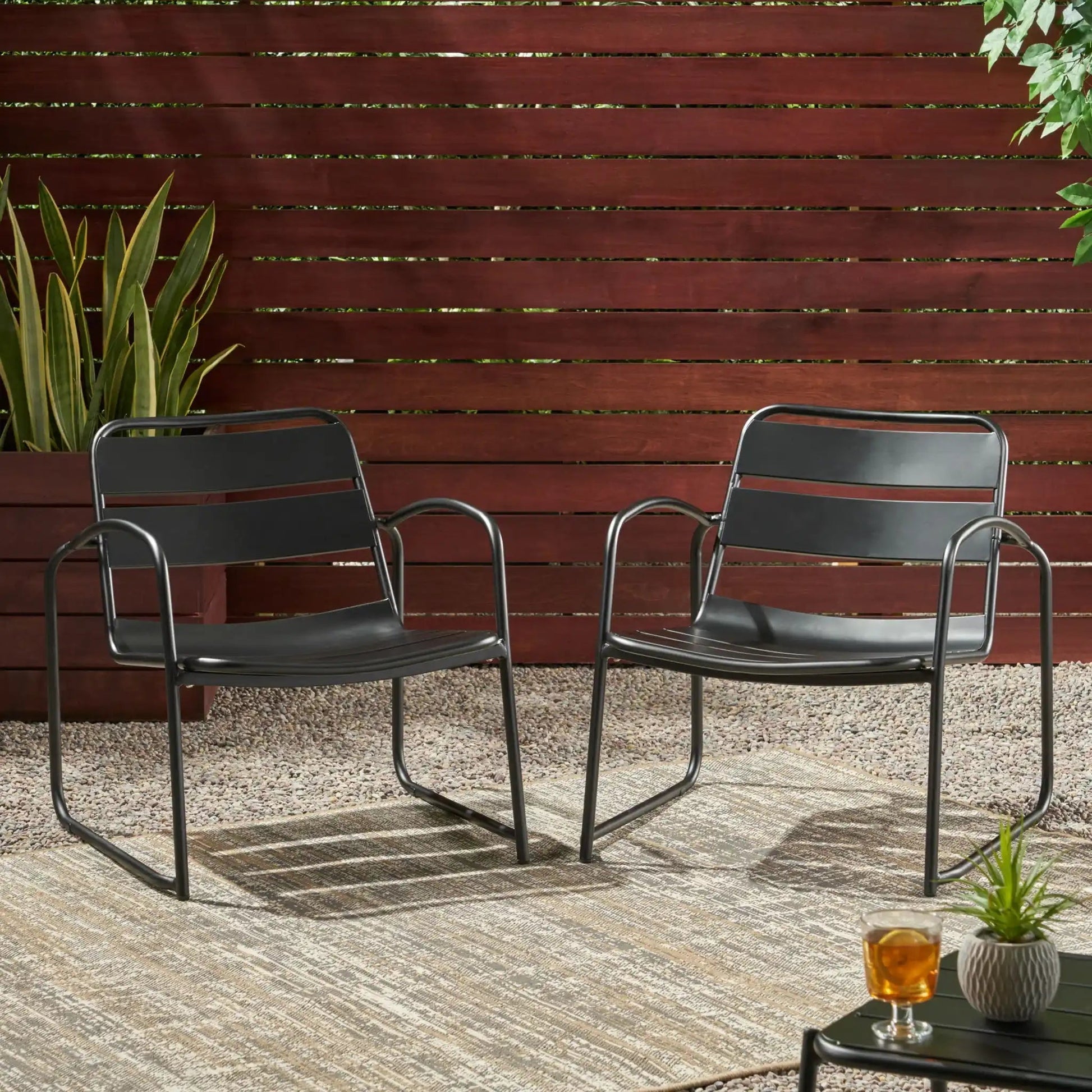 Conrad Outdoor Chair pair by HouseOfZazla, black metal frame with curved arms and mesh seating on Tampa Home & Garden Store