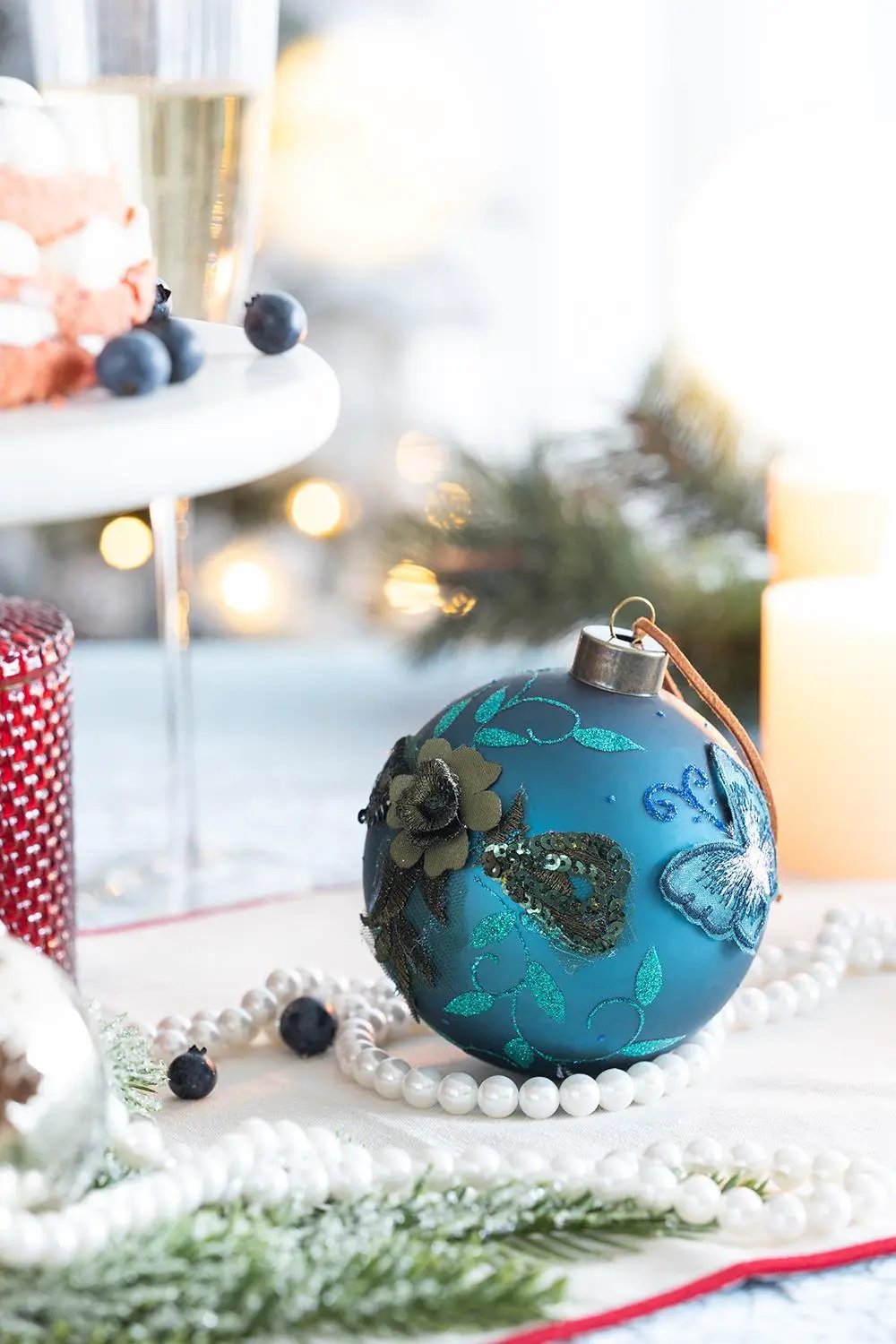 Glass blue Christmas ball ornament with teal glitter floral pattern by Unique Piece Furniture on Tampa Home & Garden Store