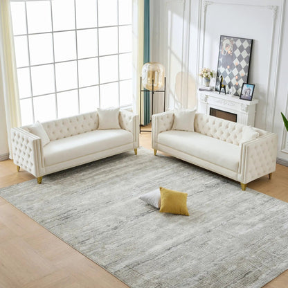 Two white tufted deep-seat sofas with button nailhead and square arms in a bright living room on Tampa Home & Garden Store