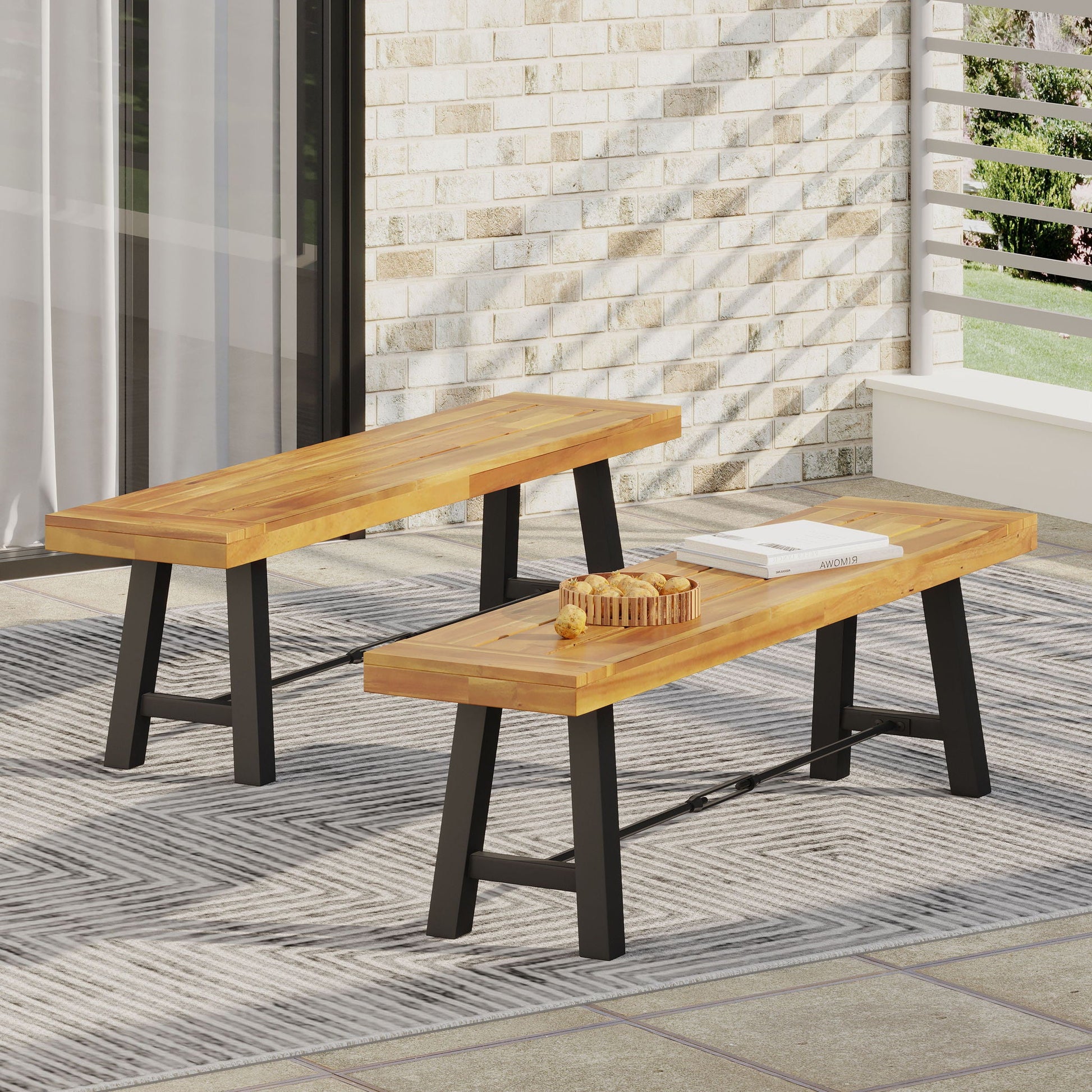 Catriona teak outdoor benches, two units, with black metal legs on a brick patio on Tampa Home & Garden Store