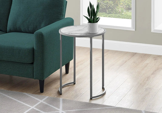 Round accent side table with white marble top and gray metal legs beside a teal sofa on Tampa Home & Garden Store