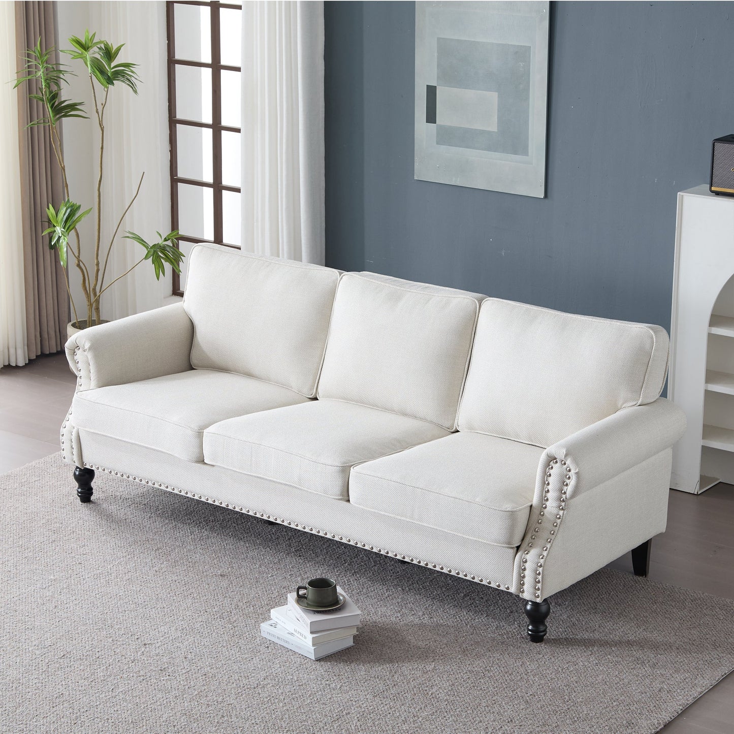 Cream faux leather 83 Inch rolled-arm sofa with nailhead trim and dark turned legs on Tampa Home & Garden Store