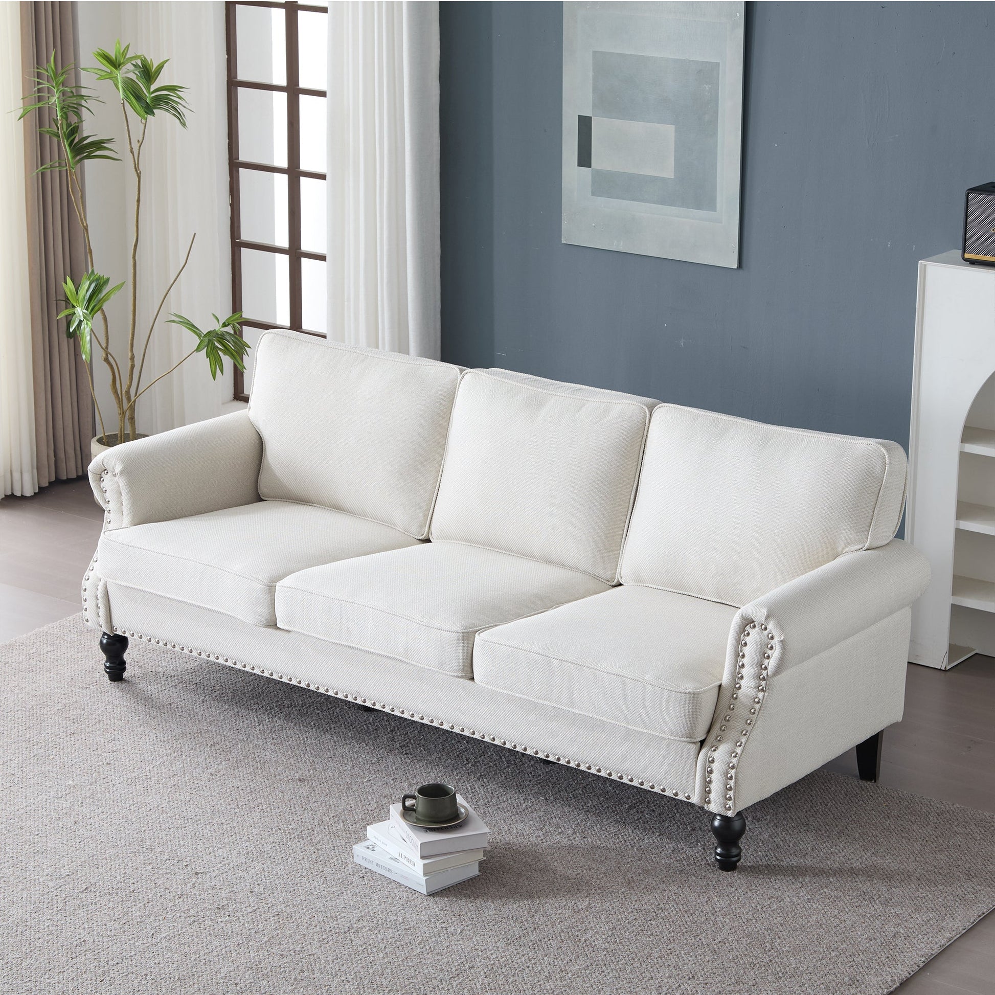 Cream faux leather 83 Inch rolled-arm sofa with nailhead trim and dark turned legs on Tampa Home & Garden Store